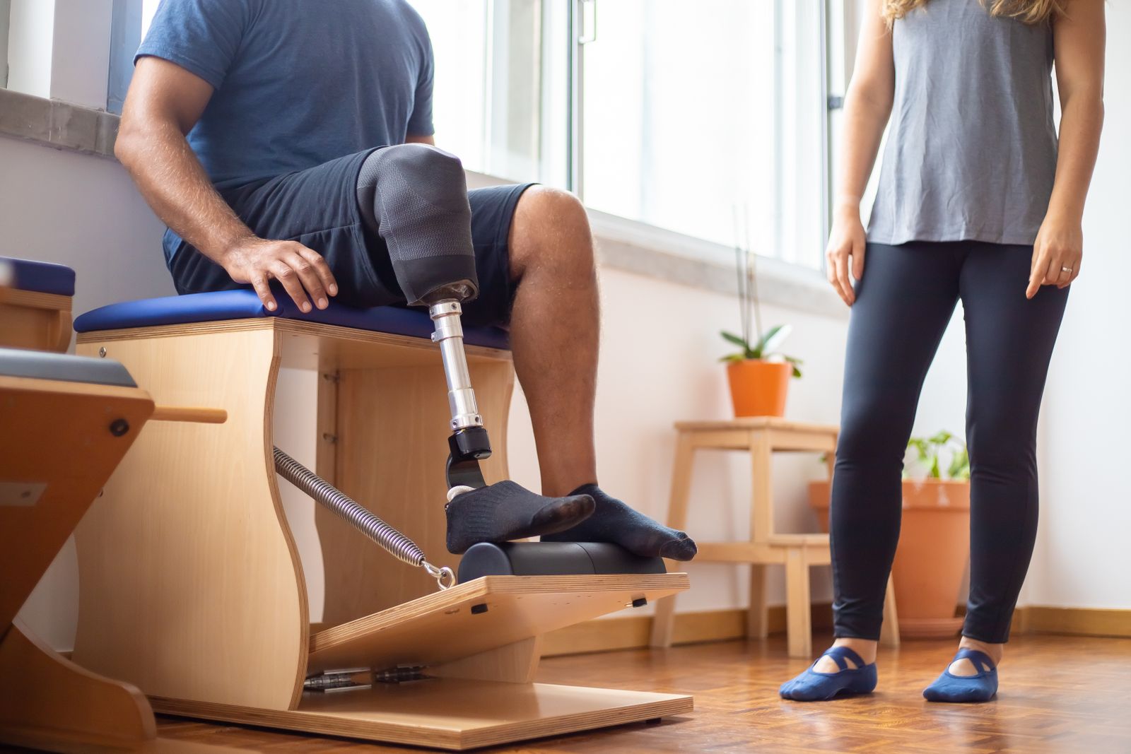 Physiotherapist supervising a patient through a rehabilitation exercise