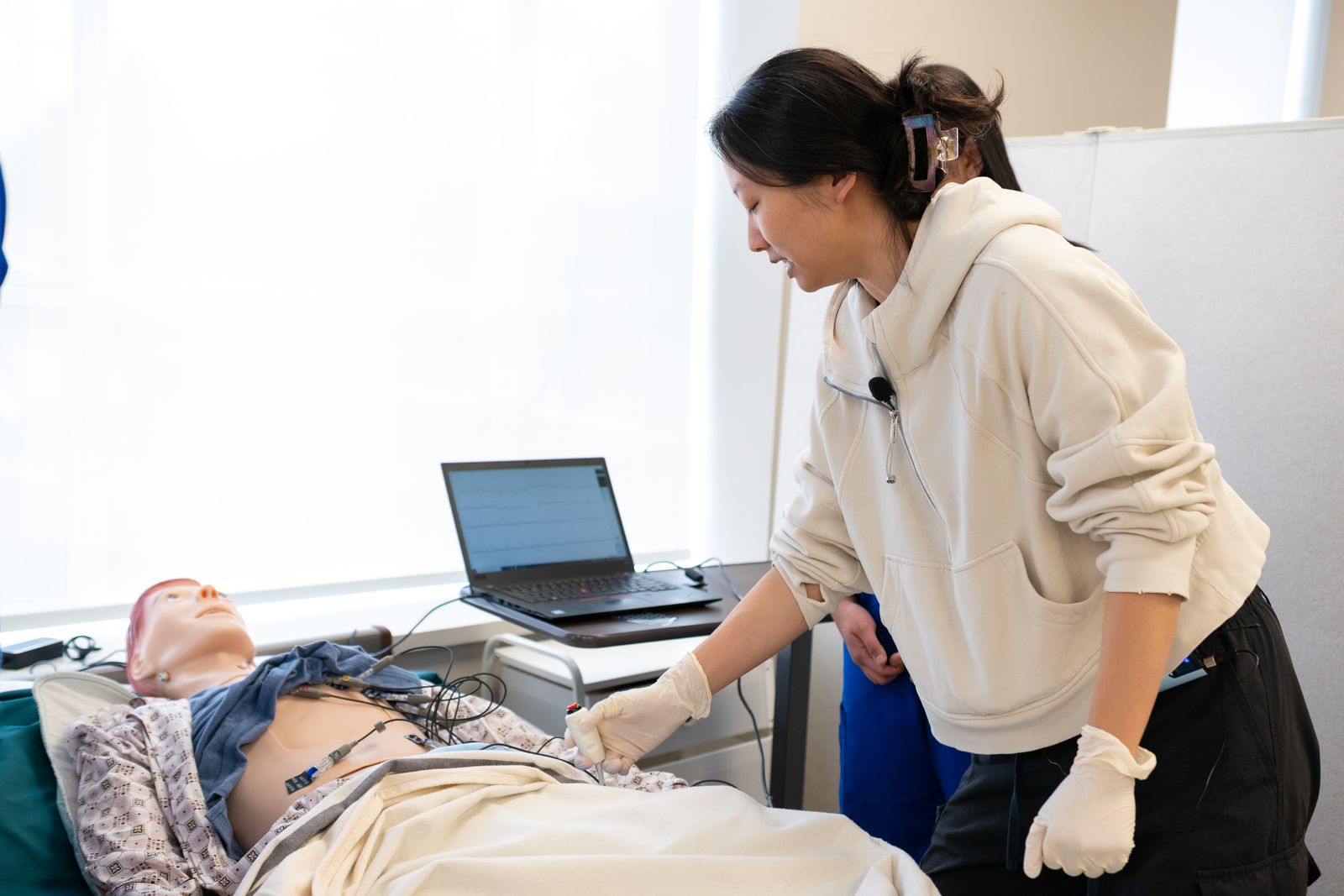 Clinician teaching a hands-on technique in a training session